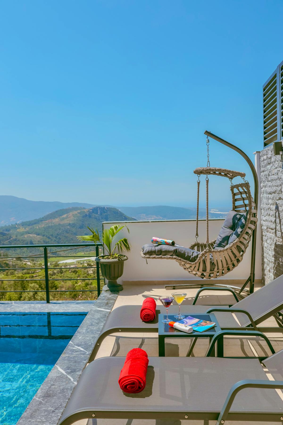 Elevated pool terrace with lounge seating and scenic view
